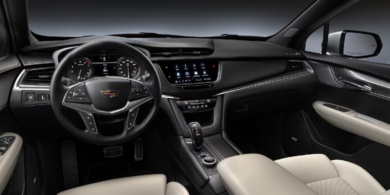 Interior view of the infotainment tech, steering wheel and dashboard in the 2025 Cadillac XT5 for sale in Phoenix, AZ