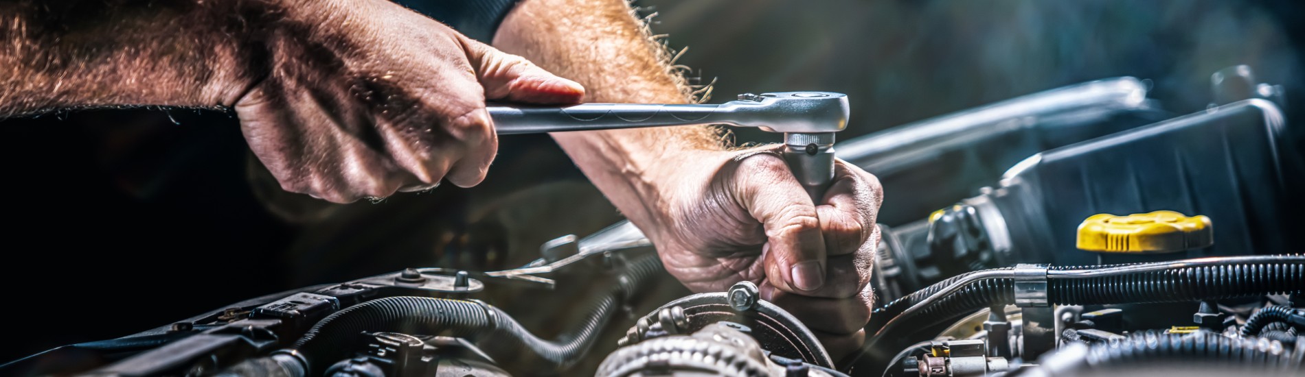 Cadillac technician working on car engine