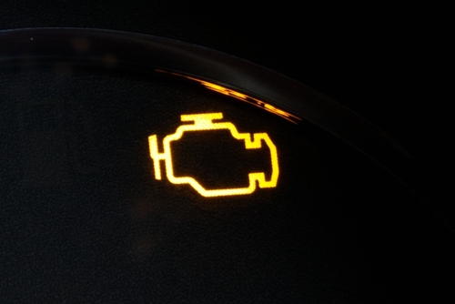 Check engine light illuminated on the dashboard of a car.