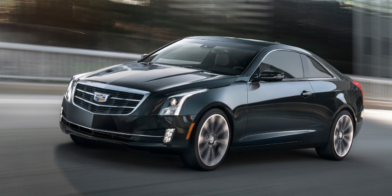 Front exterior view of a black 2019 Cadillac ATS driving on a clear highway
