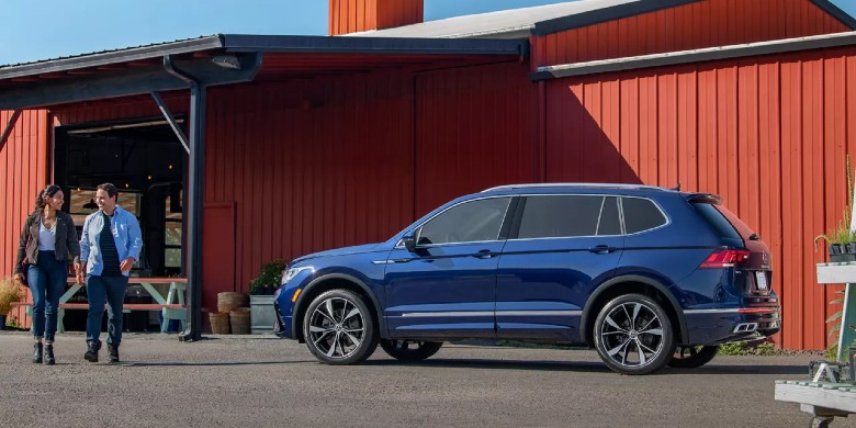 Rear exterior view of the 2024 Volkswagen Tiguan parked in front of a barn in Racine, WI