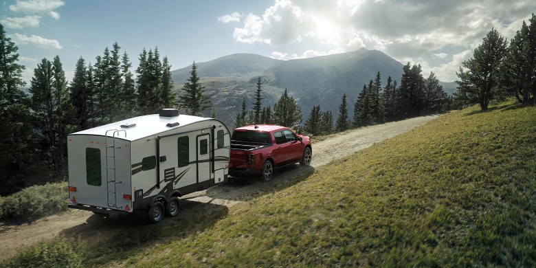 2026 Ford Maverick towing a travel trailer on a mountain road