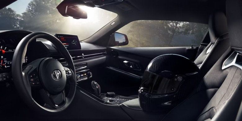 Interior view of the technology, steering wheel, and dashboard in the 2026 Toyota Supra