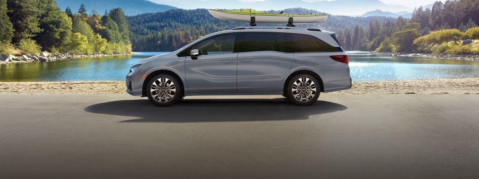 2027 Honda Odyssey family loading gear into the open cargo area