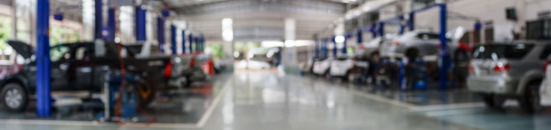 Cars lined up on lifts in a vehicle service center