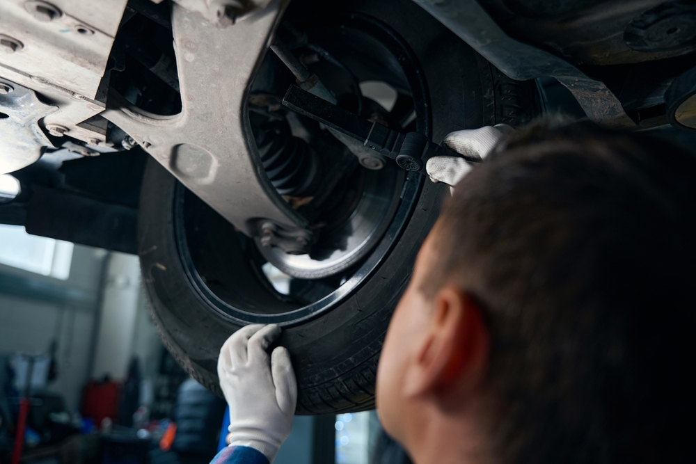 Chevy mechanic checking car brakes