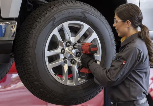 Chevy mechanic tightening bolts during service