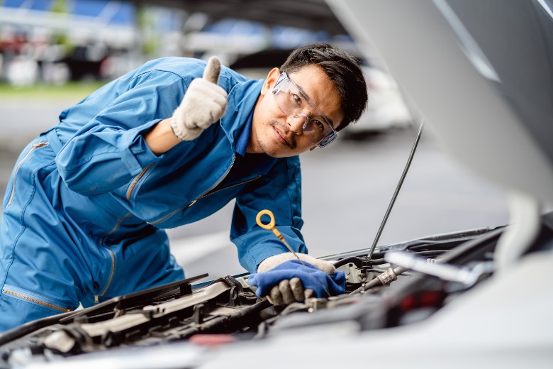 mechanic checking oil