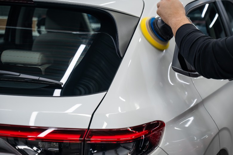 Technician applying a final polish to a finished collision repair at Olson Chevrolet