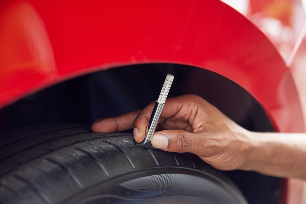 checking tire tread depth with a quarter