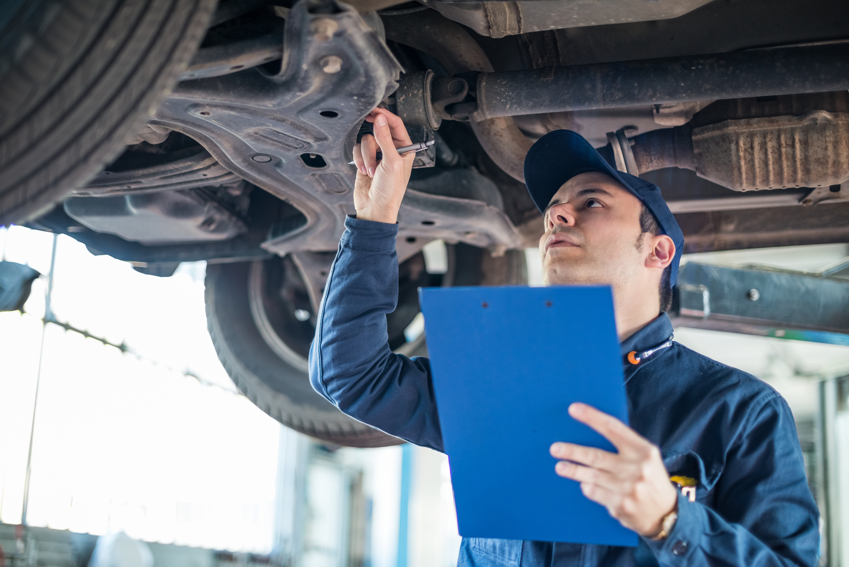Technician inspecting brake system