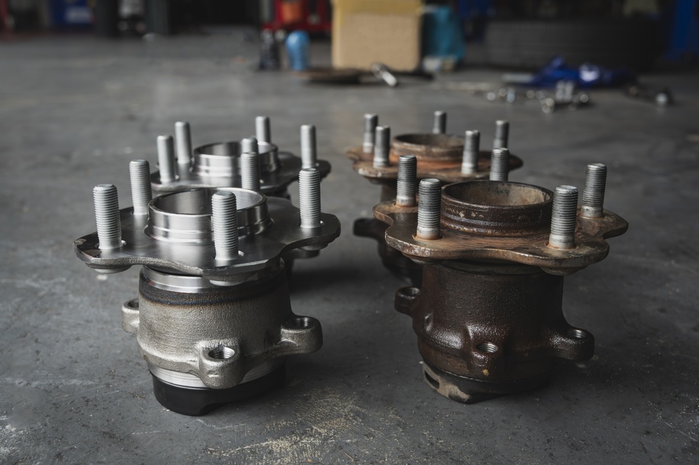 Service technician replacing a worn wheel bearing and hub assembly on a Kia