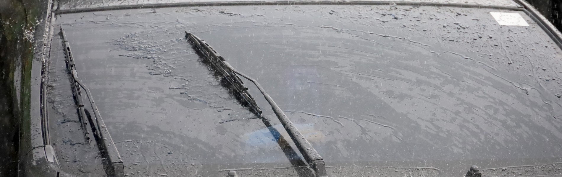 Rain on a car windshield while driving