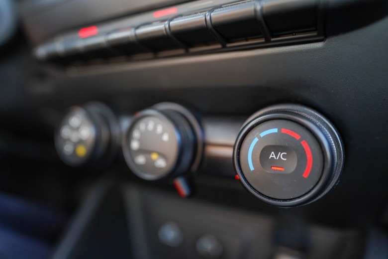 Adjusting the climate control dials for the air conditioning system
