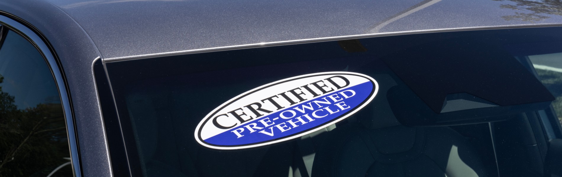 Certified Pre-owned vehicle sticker on the corner of a car's windshield