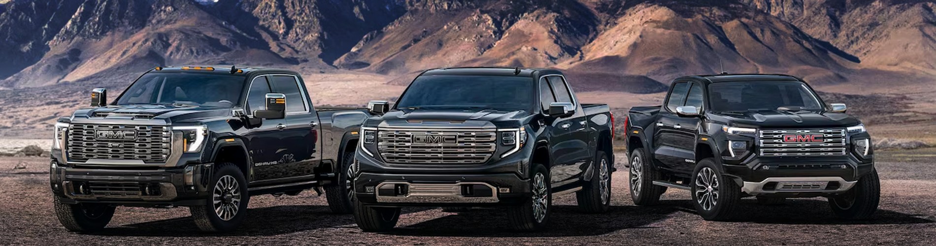 GMC Trucks lineup up against a mountainous background