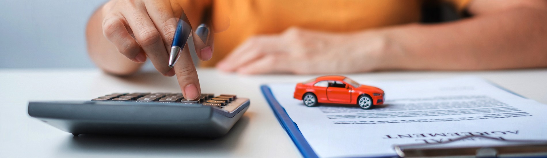 Someone using a calculator at Keweenaw Chevrolet GMC in Houghton, MI