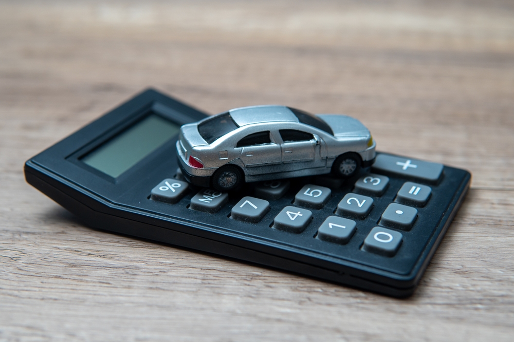 Toy car sitting on top of a calculator