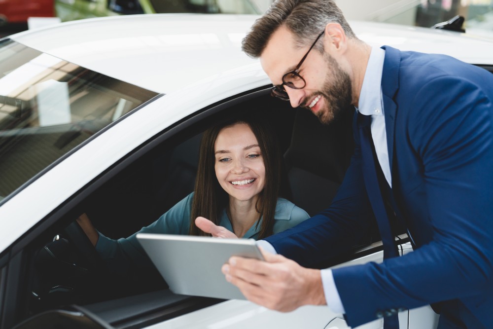 Ford dealer assisting a customer with car buying